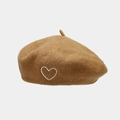 Close-up of camel wool beret featuring delicate heart embroidery and fiber texture - One Size / Camel