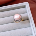 Macro detail of 18k gold plated ring featuring a large pink pearl and iridescent shell inlays - Gold-Pink