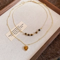 Close-up of golden double-layered necklace with heart tiger eye pendant on a tray - Double Layer Retro Heart Style (5#)