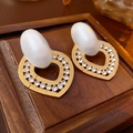 Detailed view of heart-shaped drop earrings with gold hammered finish and crystals - Gold Heart Pearl Style (Silver Needle)