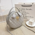 Light grey round quilted crossbody bag with diamond stitching and flamingo pearl tassel - Gray