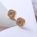 Macro shot of gold square earrings featuring a pavé setting with sparkling clear zircons - D28 Gold Pave Square