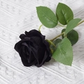 Single artificial velvet black rose with green leaves on white knit background - Black (Velvet Version)