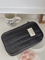 Vertical quilted nylon storage bag in black with embroidered label for travel use - Black