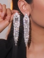 Elegant long silver tassel clip-on earrings with sparkling rhinestones on model - Star Flare Tassel Drop / Silver