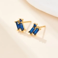 Detailed macro view of S925 sterling silver gold-plated stud earrings with blue zircon - Gold Blue Zircon