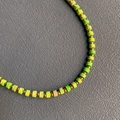 Handmade beaded necklace with bright green cylindrical stones and gold metal spacers - Size 7