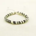 Handmade woven bohemian surf bracelet with black and white checkered geometric patterns - US 12