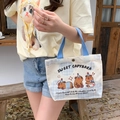Off-white canvas tote bag featuring a cute cartoon capybara and bright blue handles - Capybara Sweet Dream-Beige