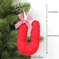 Red felt Christmas tree ornament letter U with plaid bow and gold bell hanging on branch - U-Bell
