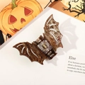 Macro shot of glittery marble bat hair claw clip with Halloween festive decorations - Tortoise Bat-Coffee
