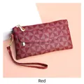 Detail of red geometric triangle pattern PU leather clutch with gold metal zipper and strap - Red