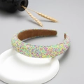 Detail of colorful glitter headband with candy-colored particles on white stand - Green Gradient