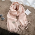 Soft pink faux cashmere scarf with tassels and brand label on a plush fur background - 200*65cm / Apricot