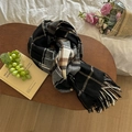 Classic plaid checkered scarf with tassels on wooden table in a cozy home setting - Black Plaid