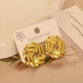 Polished golden stainless steel hollow twist earrings on a minimalist display card - Gold Twisted Spiral (3)
