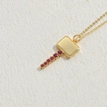 Gold plated hammer necklace with red zircon stones on a white stone background - Large Key / Gold with Rose Red Zircon