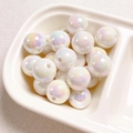 Macro shot of 14mm iridescent pearlized round acrylic beads for DIY jewelry making - White