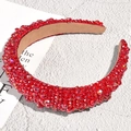Macro shot of red beaded padded headband with sparkling crystals and plush lining - Red