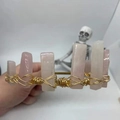 Detailed close-up of handmade rose quartz crystal crown secured with gold wire wrapping - Rose Quartz Gold Wire Gold Flat Headband