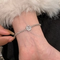 Close-up of sparkling square-cut zircon bracelet on a wrist with silver-tone chain - Square Halo Pendant / Silver