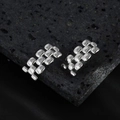 Silver geometric link earrings with watch strap design on black volcanic rock background - Silver