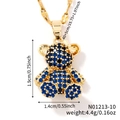 Elegant gold bear pendant necklace with navy blue pavé crystals and bow detail - Gold/Blue Zirconia