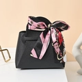 Elegant black leather wedding favor bag with floral silk scarf handle and ribbon bow - Black
