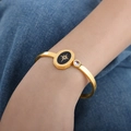 Minimalist gold evil eye bangle with black enamel oval and sparkling star detail - Gold Color (Z295)