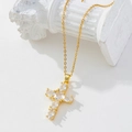 Gold plated cross pendant necklace with zircon stones on a white display column - Gold/Prong Set White Zirconia Cross/X