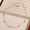 Detailed view of silver necklace with five purple crystal flower pendants in a velvet box - Purple Flower - Platinum