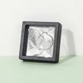 Silver twisted rope earrings displayed in a black square 3D floating jewelry box - Black