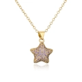 Macro detail of 18K gold-plated star pendant with pavé set purple cubic zirconia stones - Purple Zirconia