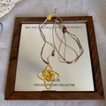 Detail of vintage gold flower pendant with hand-woven cord and bohemian beads on a mirror - Gold Hollow Flower Retro Woven Cord