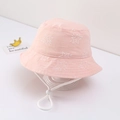 Detailed view of pink cotton baby bucket hat featuring white star print and adjustable strap. - Light Pink Star