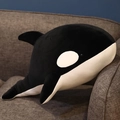 Plush orca whale pillow with soft black and white fabric on a gray sofa - Black / 60CM