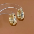 Detailed view of gold-tone U-shaped earrings with high-polish metallic finish - Gold