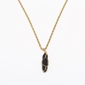 Detailed macro view of black crystal pendant wrapped in golden woven wire on a chain - Black
