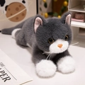 Realistic gray and white lying cat plush toy with fluffy fur and yellow eyes - Blue Cat
