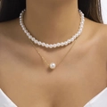 Double-layer pearl and gold necklace featuring elegant bow and heart pendant styling - SY310-Double Layer Pearl Thin Chain Stacked Necklace