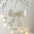 Sparkling white glitter Christmas bow ornament with sequins hanging on a snowy tree branch - 3D Bow