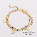 Detailed close-up of double-layer gold chain bracelet with colorful beads and coin charms - Solid Round Disc