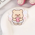 Cute acrylic bear pin featuring a beige bear holding a pink striped cup accessory - Bubble Bear
