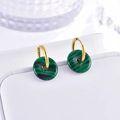 Detail of gold hoop earrings with green malachite stone pendants on white display - Dark Green