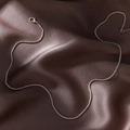 Minimalist silver water wave chain necklace displayed on dark chocolate silk background - Silver (With Chain)