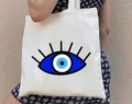White canvas tote bag featuring a large blue Greek Evil Eye graffiti print on the front - STD1804-X Minimalist Blue & White