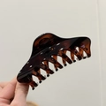 Detail of 12cm dark tortoise shell large hair claw clip for thick hair held by hand - Glossy Red Brown