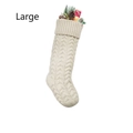 Detail of a large white cable knit Christmas stocking filled with holiday ornaments - Large Ivory