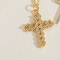 Macro shot of 14K gold-plated 3D hollow cross necklace with micro-pave cubic zirconia - Openwork Zirconia Cross