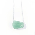 Macro shot of irregular pale green raw crystal pendant on silver link chain necklace - Aventurine